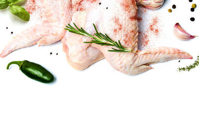 Some raw chicken wings with basil, spices, a habanero pepper, and rosemary.