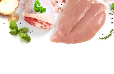 A turkey breast and leg with herbs and a sliced onion