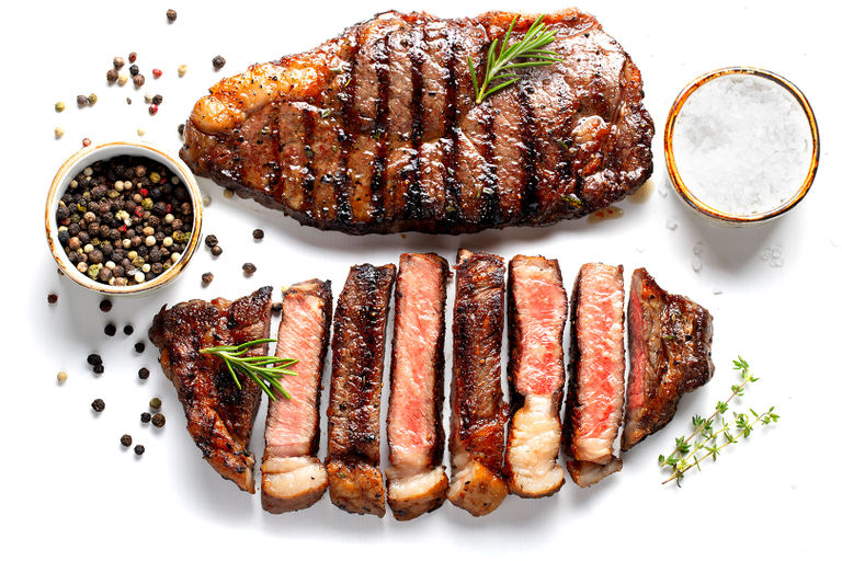 two pieces of meat with condiments