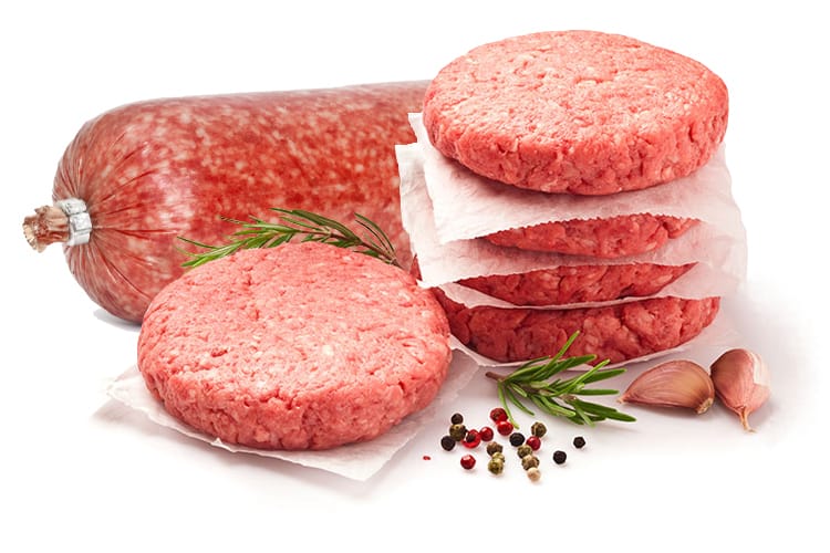 A picture of five patties of round chuck, with four stacked on top of each other, all with a square of wax paper on the bottom of them