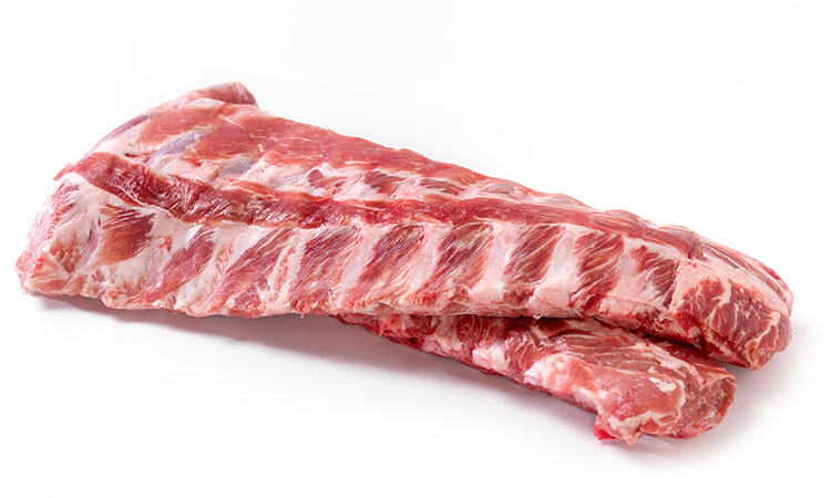 Two racks of raw pork ribs, on on top of the other