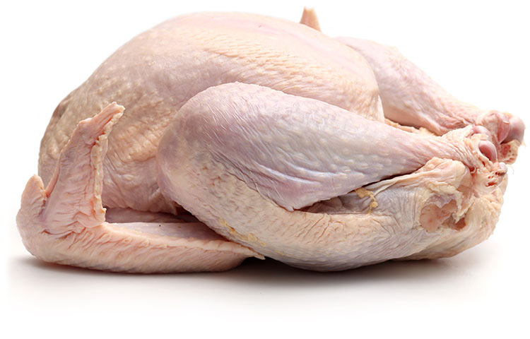 A whole raw turkey on its back